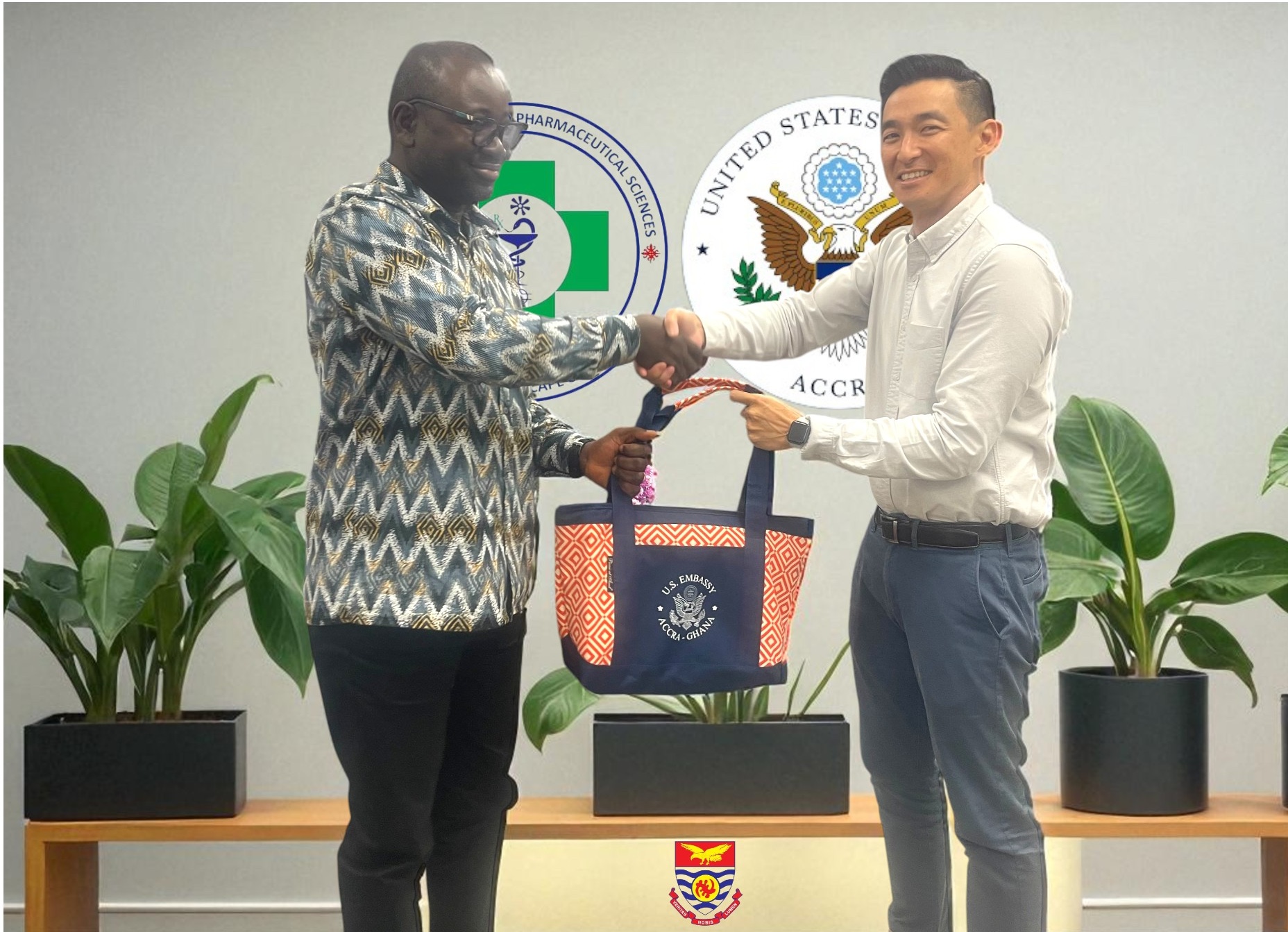 Professor Ernest Obese in handshake with the US Embassy delegate